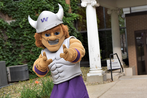 Waldorf University mascot, Warrick, pointing at camera